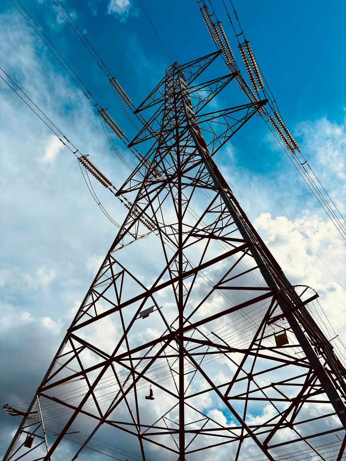 Detailed view looking upward through a lattice transmission tower